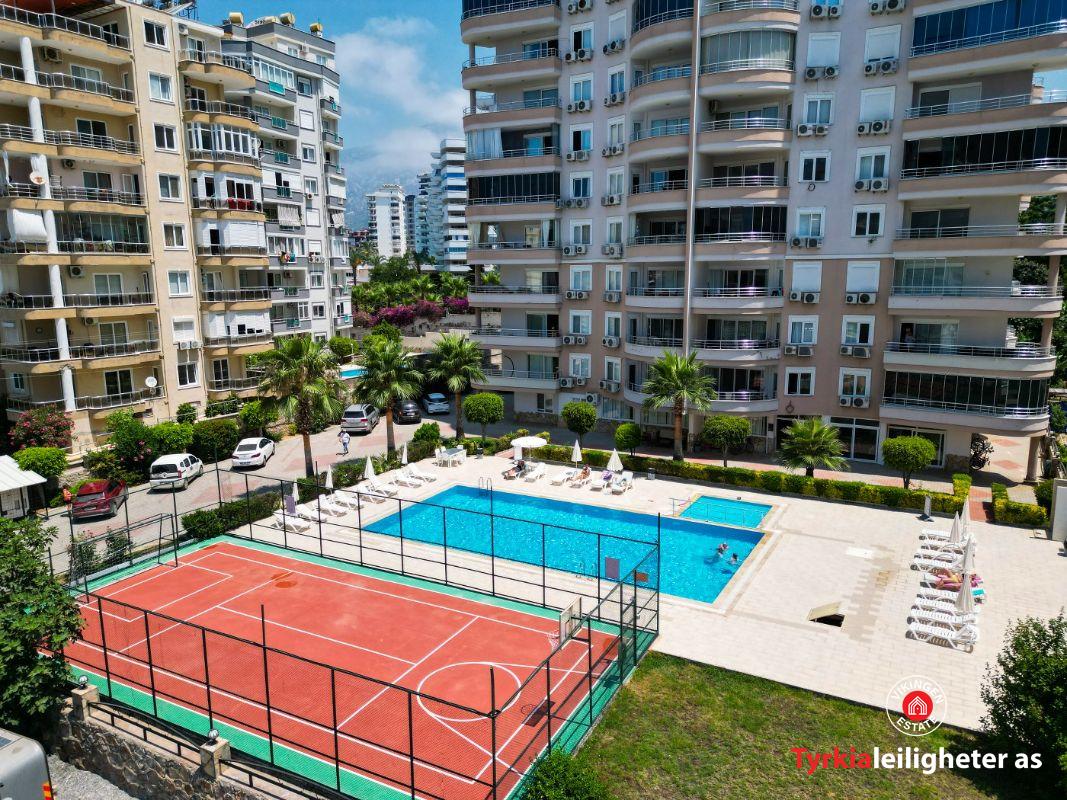 Courtyard from above — pool, sports area, the buildings.
